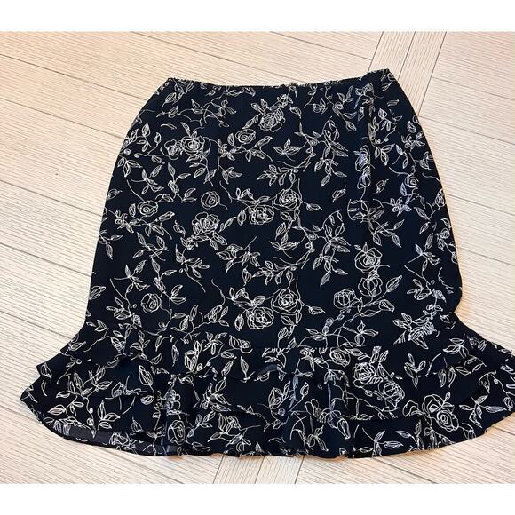 Floral print zip closure w/ elastic waist knee length skirt with ruffle trim. 12 - Picture 1 of 9
